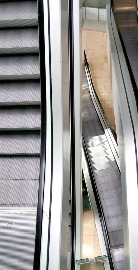 the escalators are long and empty in an area that looks like it is a mall