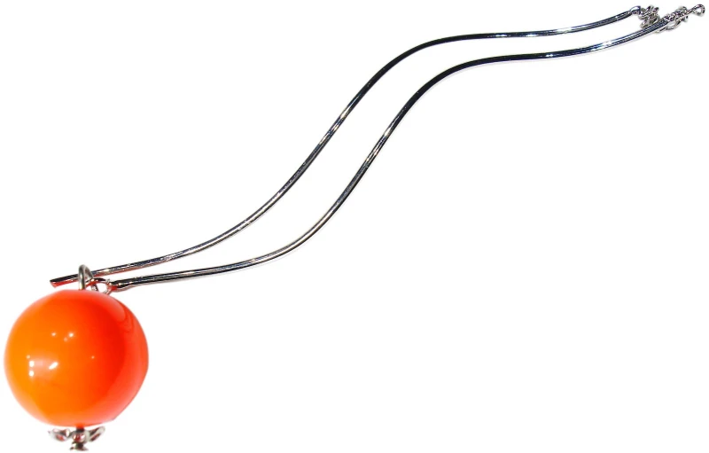 an orange ball on a silver long string