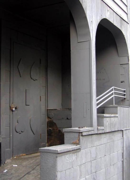 the entrance to a building with some concrete stairs