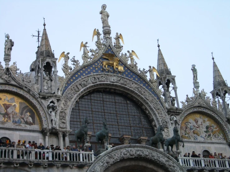 many people on the balconies on a church's roof