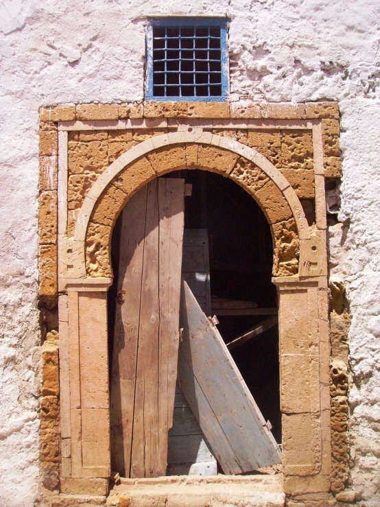 a door to a building with a tall window