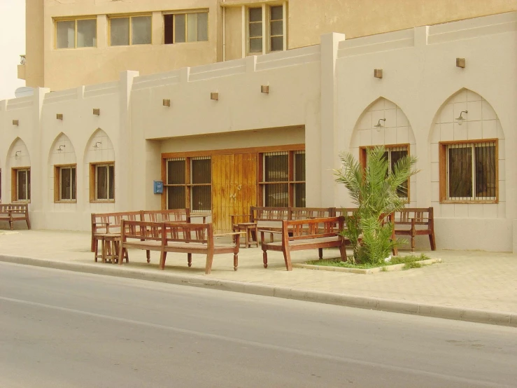 a row of tables and chairs on the sidewalk