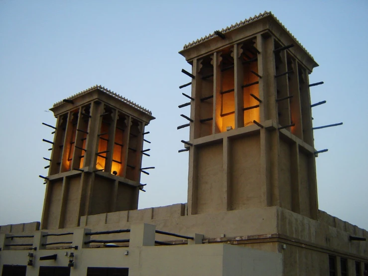 two very tall clock towers on top of a building