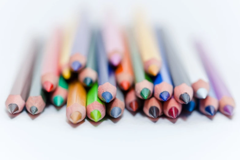 colored pencils that are lying side by side