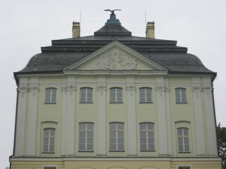 a building with three tall arched windows and a steeple above the roof