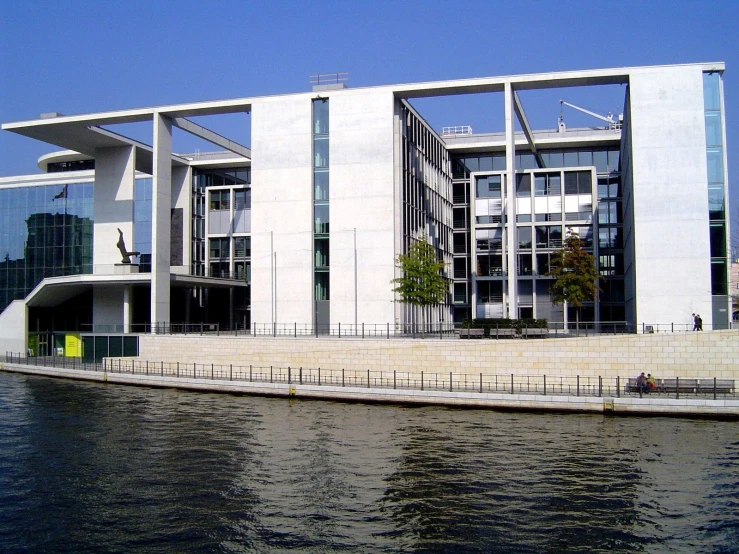 the front of a large building by the water