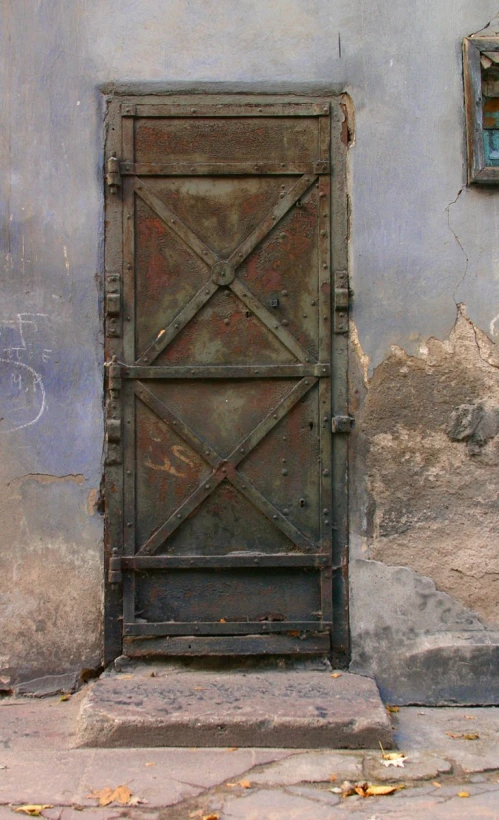 the old iron door is placed outside of the building