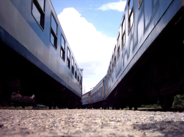 two blue and white train cars sitting next to each other