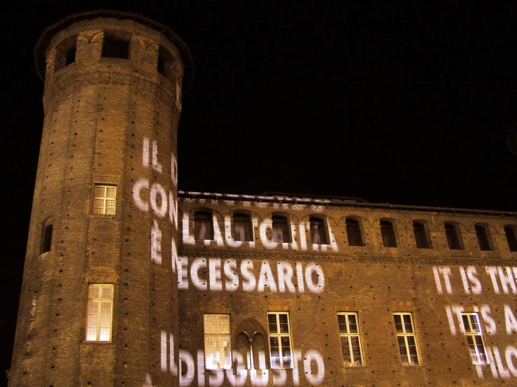 large brick building with words projected in front of it