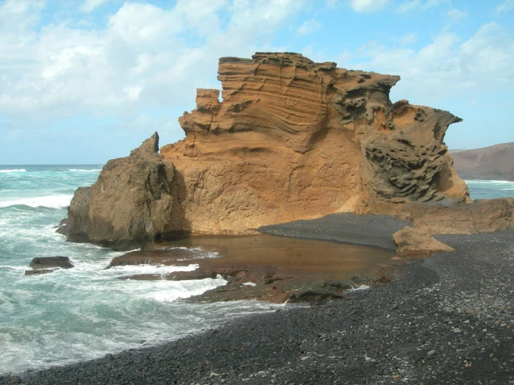 the water has been choppy and turbulent by the cliffs