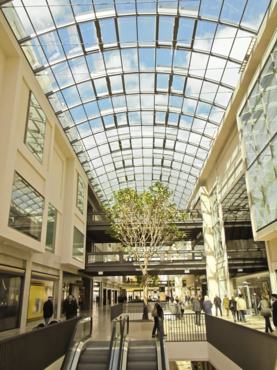 the ceiling of a shopping mall, with many people