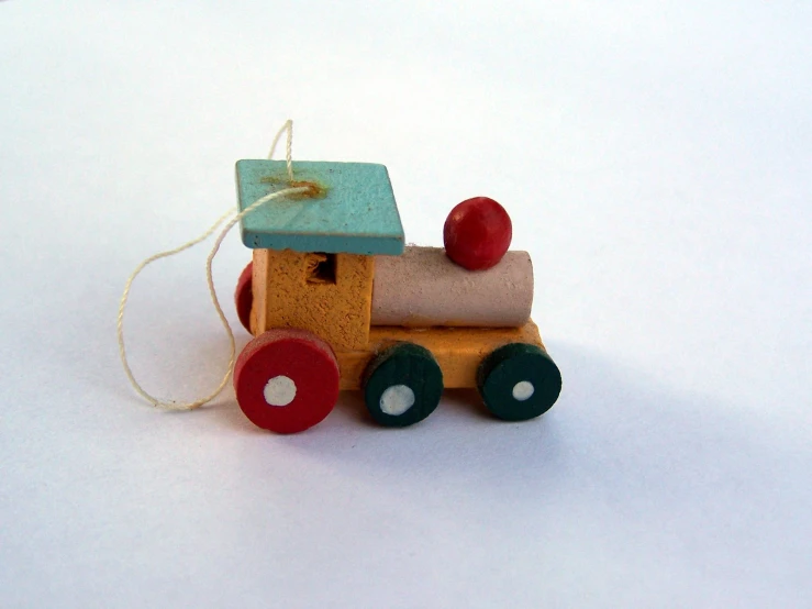 small toy truck with wheels that are painted brown and blue