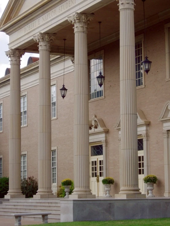 there are large columns that have been set around the front of a large building