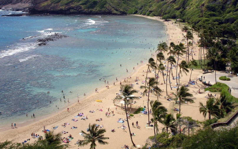 many people are enjoying the beach and in the water