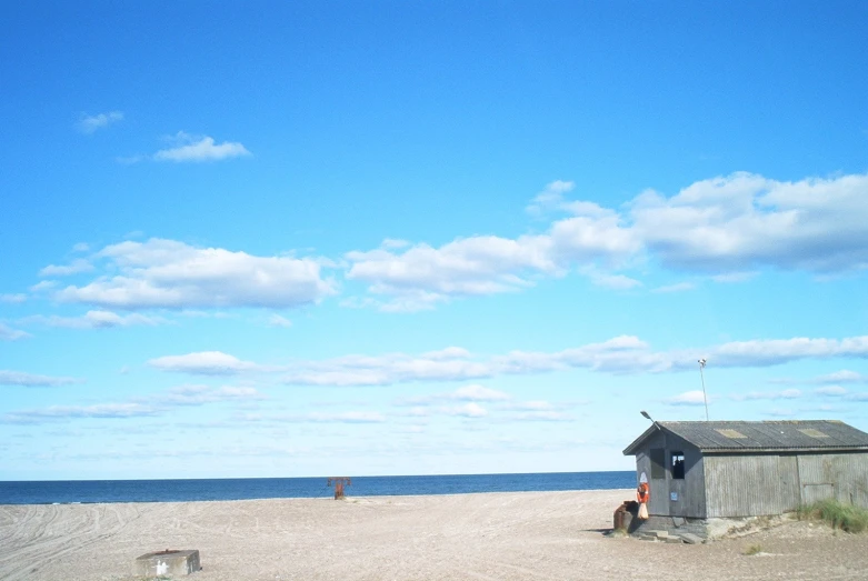 a beach hut on the shore of the ocean