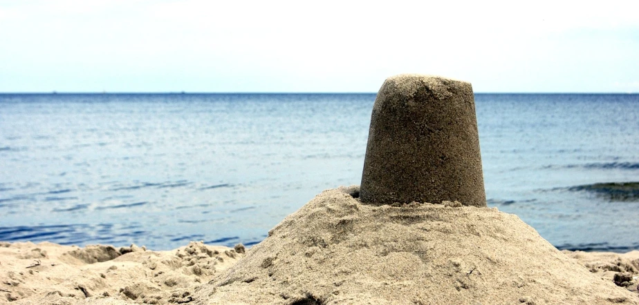 a sandcastle on a beach near the ocean