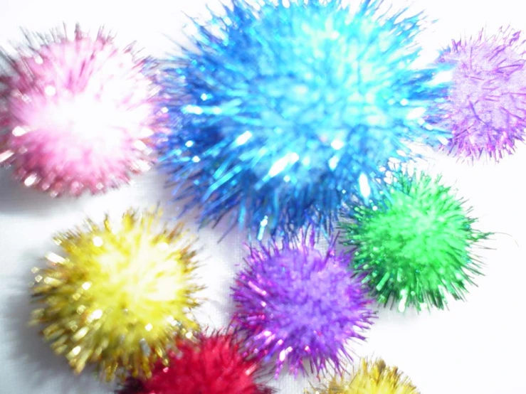 seven colored fireworks on a white background with copyspace in the middle