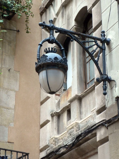 a street light is hanging on the side of a building