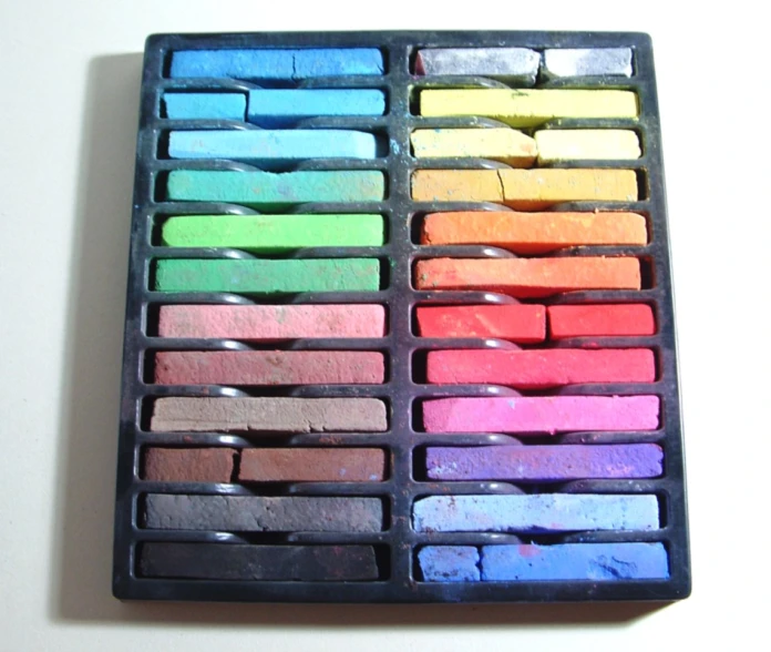 an empty tray holds colored powdered clay