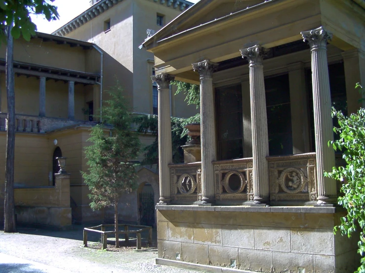 an old stone building sitting on the side of the road