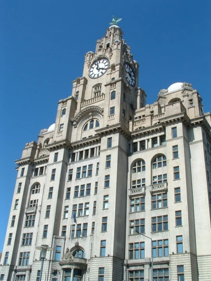 the large building has many windows and clock