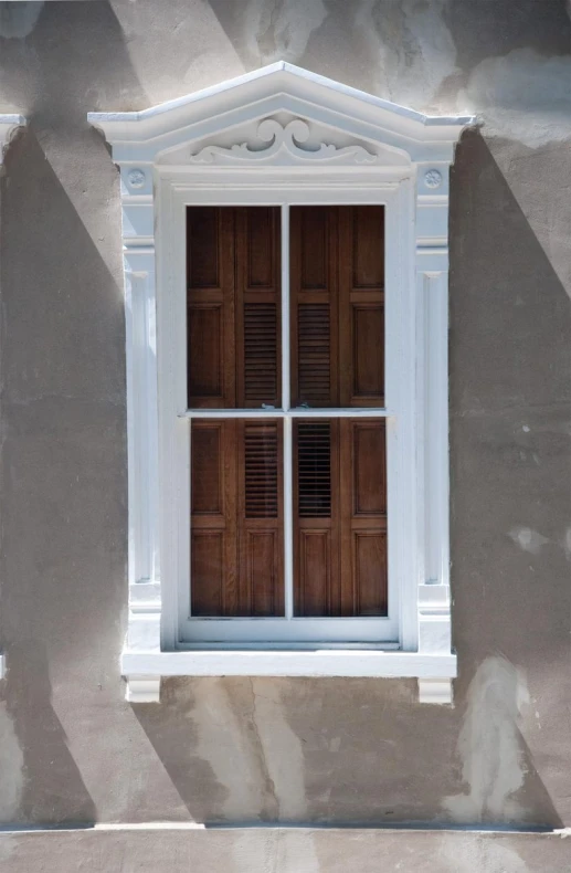 an old house with a wood window and ornate details