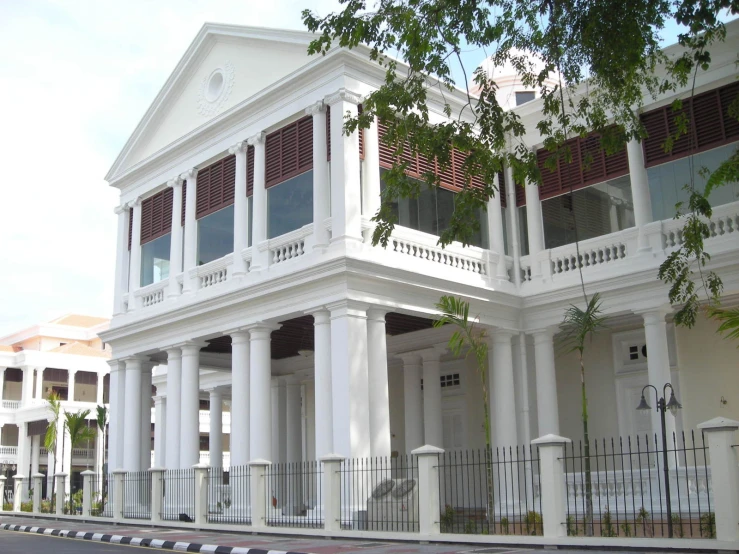 an old building is white with ornate columns