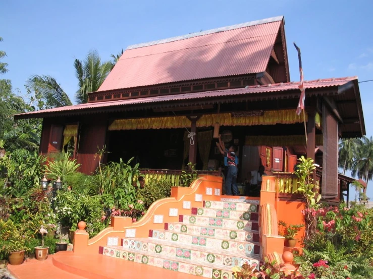 some steps leading up to a house with red roof