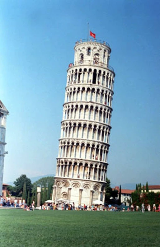 a large tall leaning tower in the middle of a park