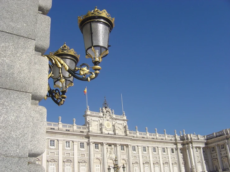 an ornate wall light outside a palace