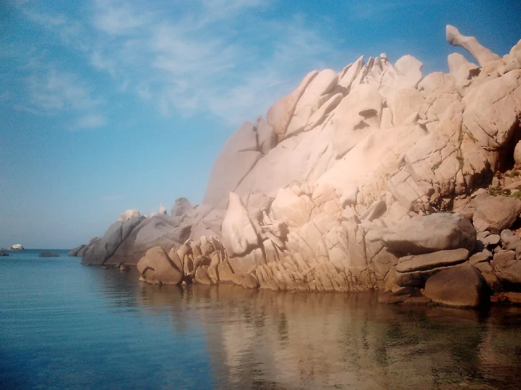 large rocks and rock formations rise above the water