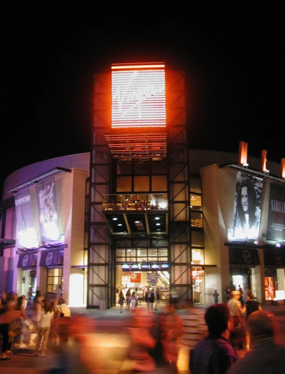 many people are walking in front of a theater