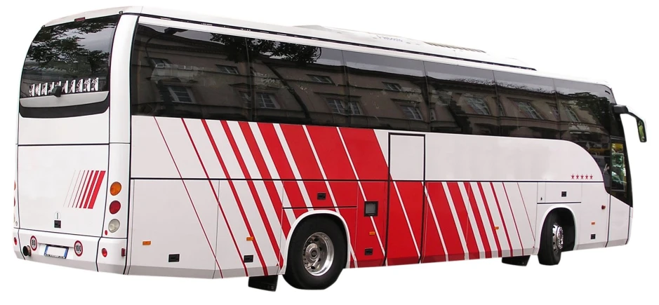a white and red passenger bus parked in front of a building