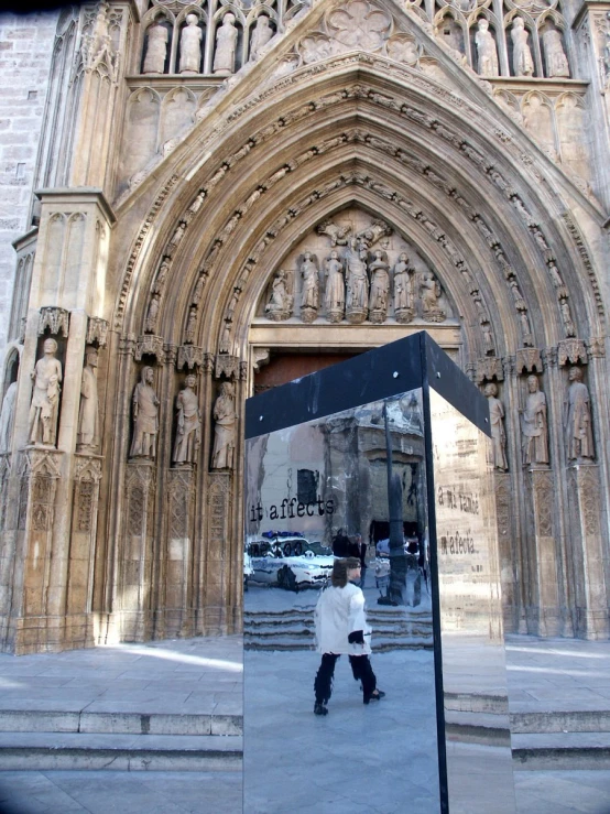 a person walking past an entrance to a building