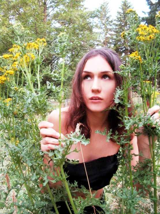 a woman standing in a field of tall grass