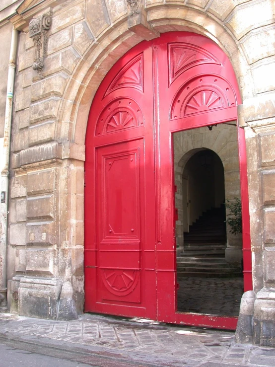 a red door on the outside of an old building