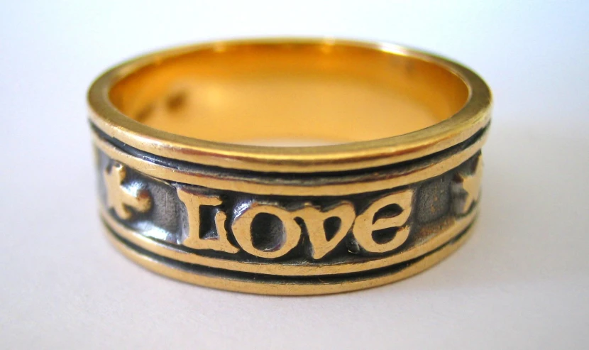 a gold ring with a i love sign in the middle