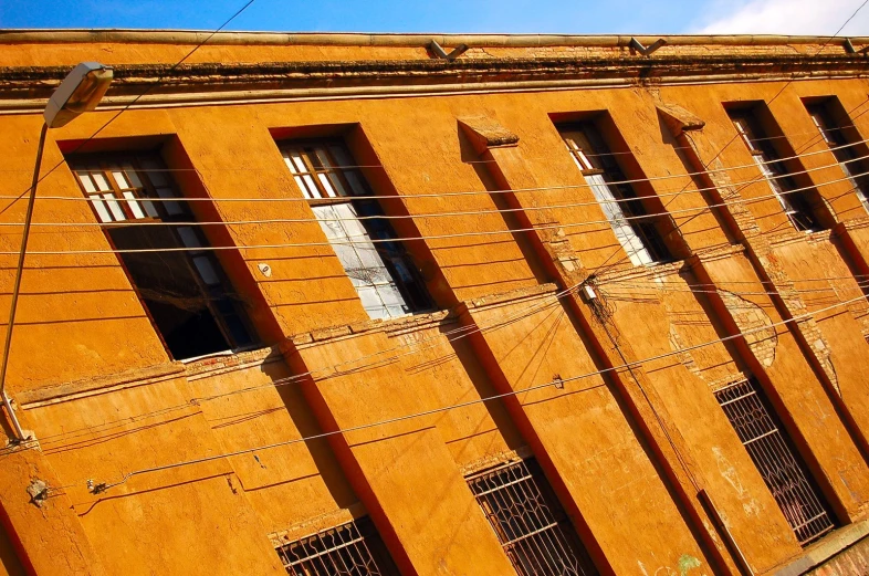 a row of orange buildings line the street