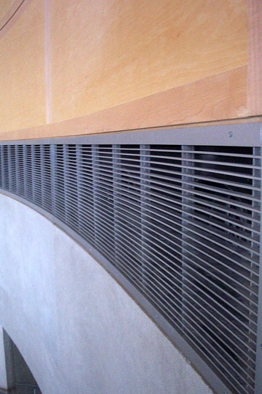a close up view of a air conditioner in front of wood