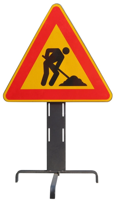 a warning sign is standing on top of a pole