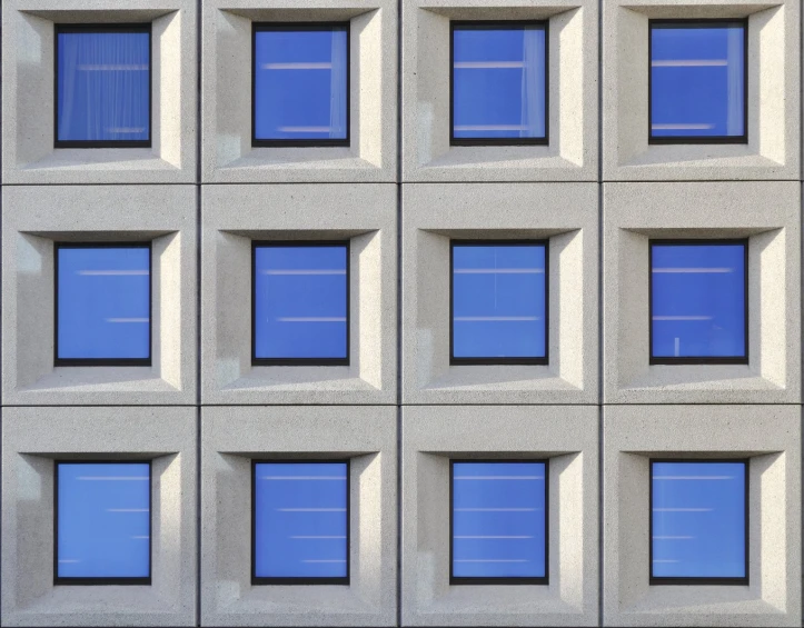 this is a wall with some windows reflecting the sky