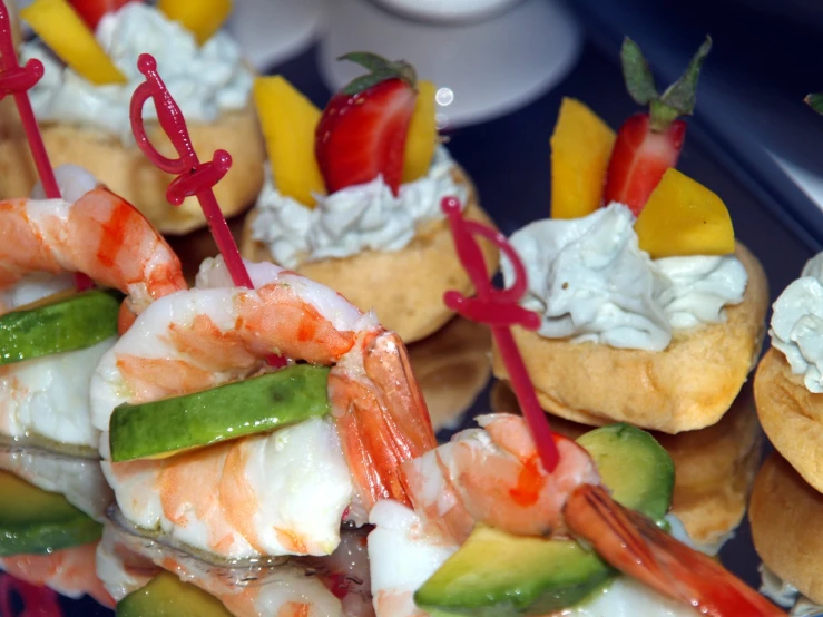 many skewered vegetables with shrimp on them