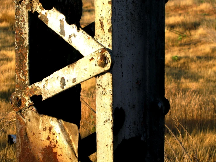 an old run down gate stands in an open field