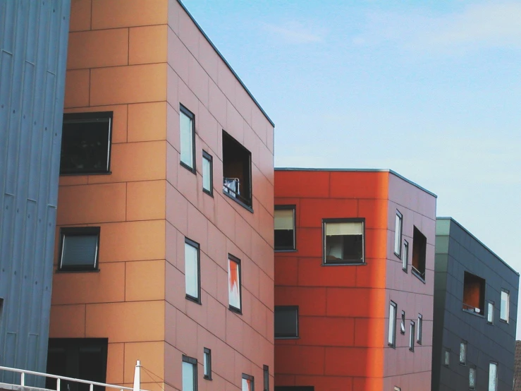 two red buildings with windows on the side of them