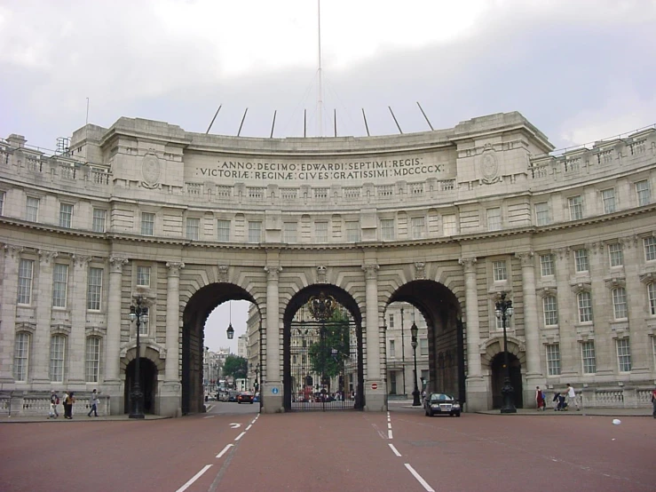 an archway leading to a white and gray building with pillars and arches