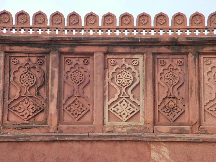 a building with several ornamental designs on the side of it