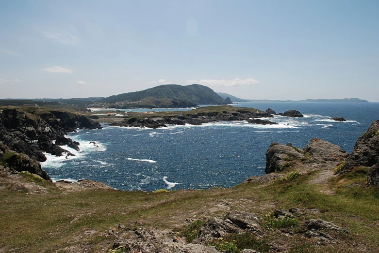 a view from an area covered in rocks next to the ocean