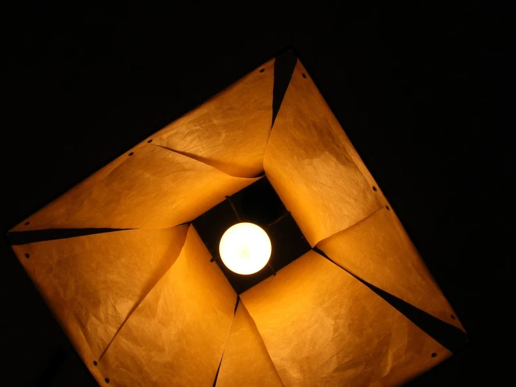 a lit light bulb sitting in the middle of a square frame