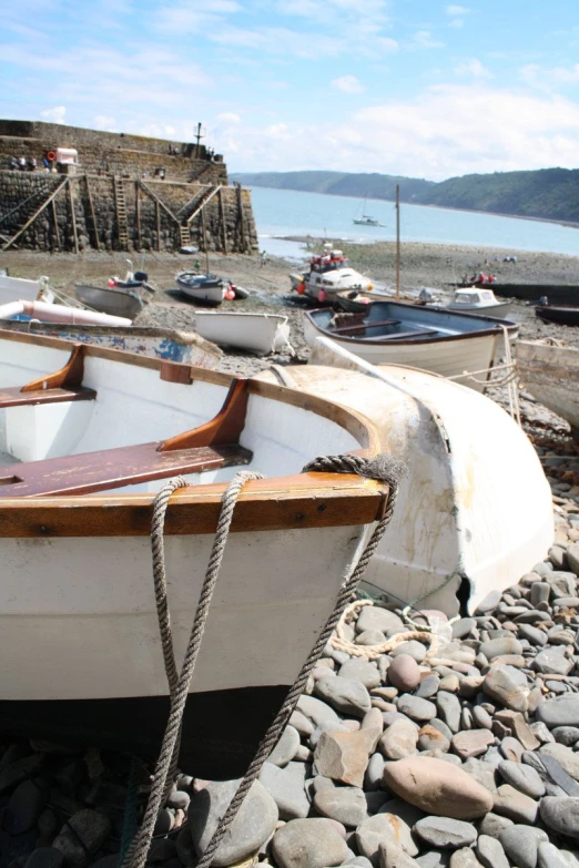 two small boats sitting next to each other on rocks