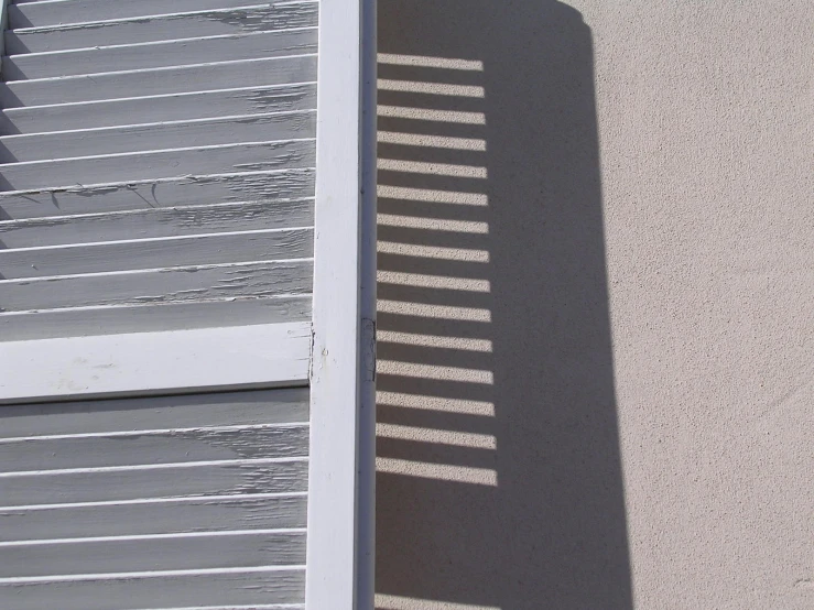 shadows on the outside of the house as seen by someone holding their cell phone